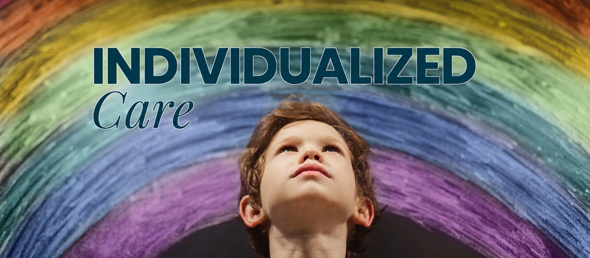 Individualized care — child looking up at a chalk rainbow